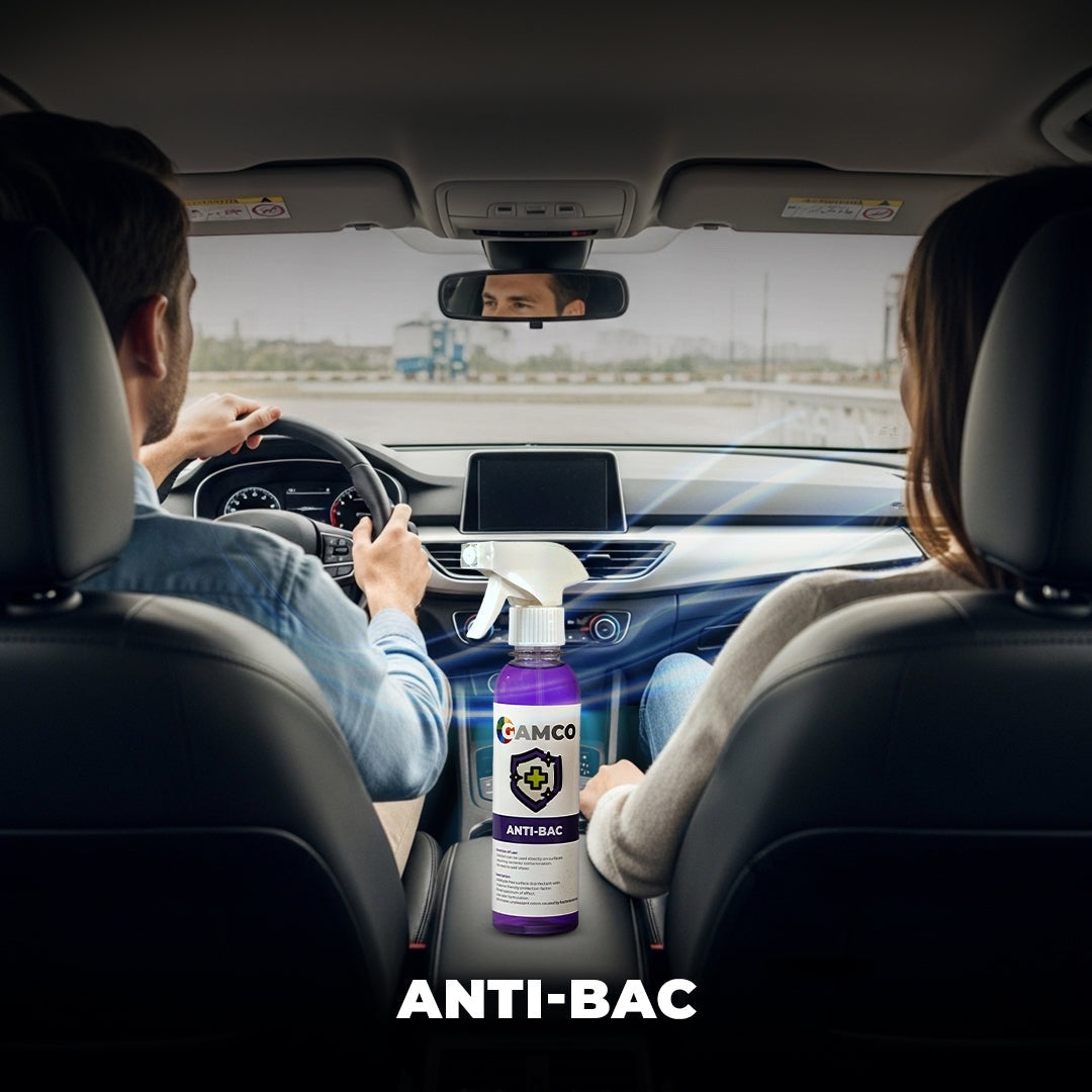 GAMCO Anti-Bac disinfectant spray bottle on car console, safe for surfaces, kills 99.9% of germs.