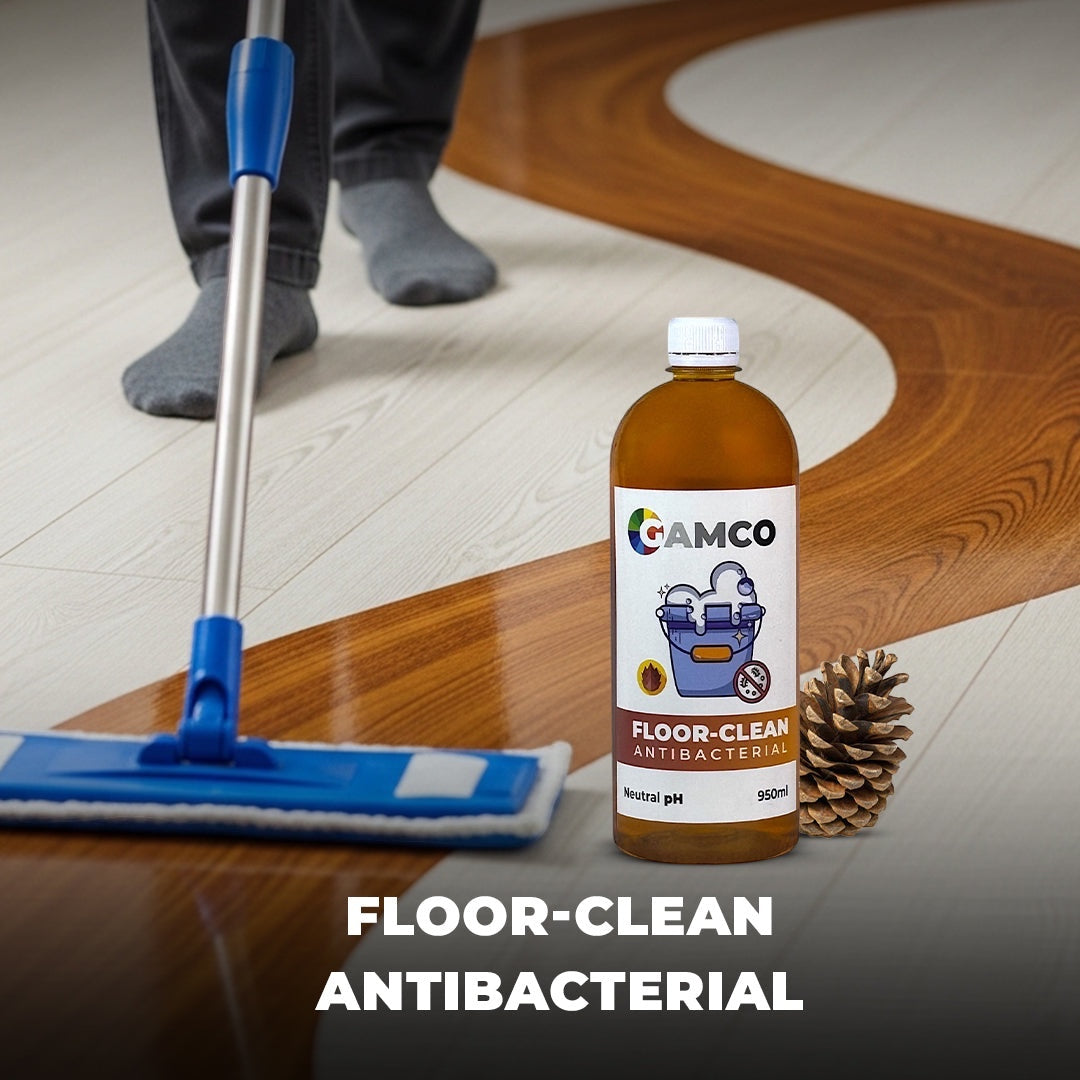 GAMCO Store Floor Clean Antibacterial cleaning liquid in a brown bottle with a mop and pine cone on a polished floor.